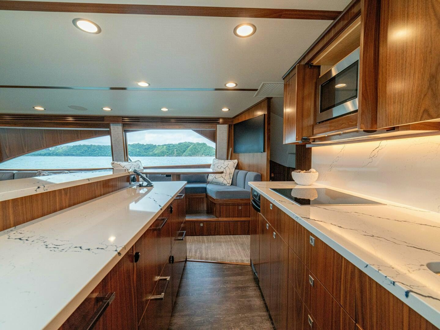 a kitchen with a large sink and a couch aboard PURA VIDA Yacht for Sale