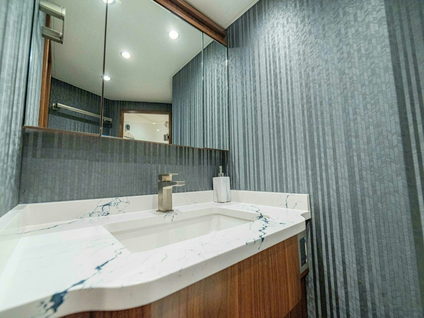 a bathroom with a large mirror aboard PURA VIDA Yacht for Sale