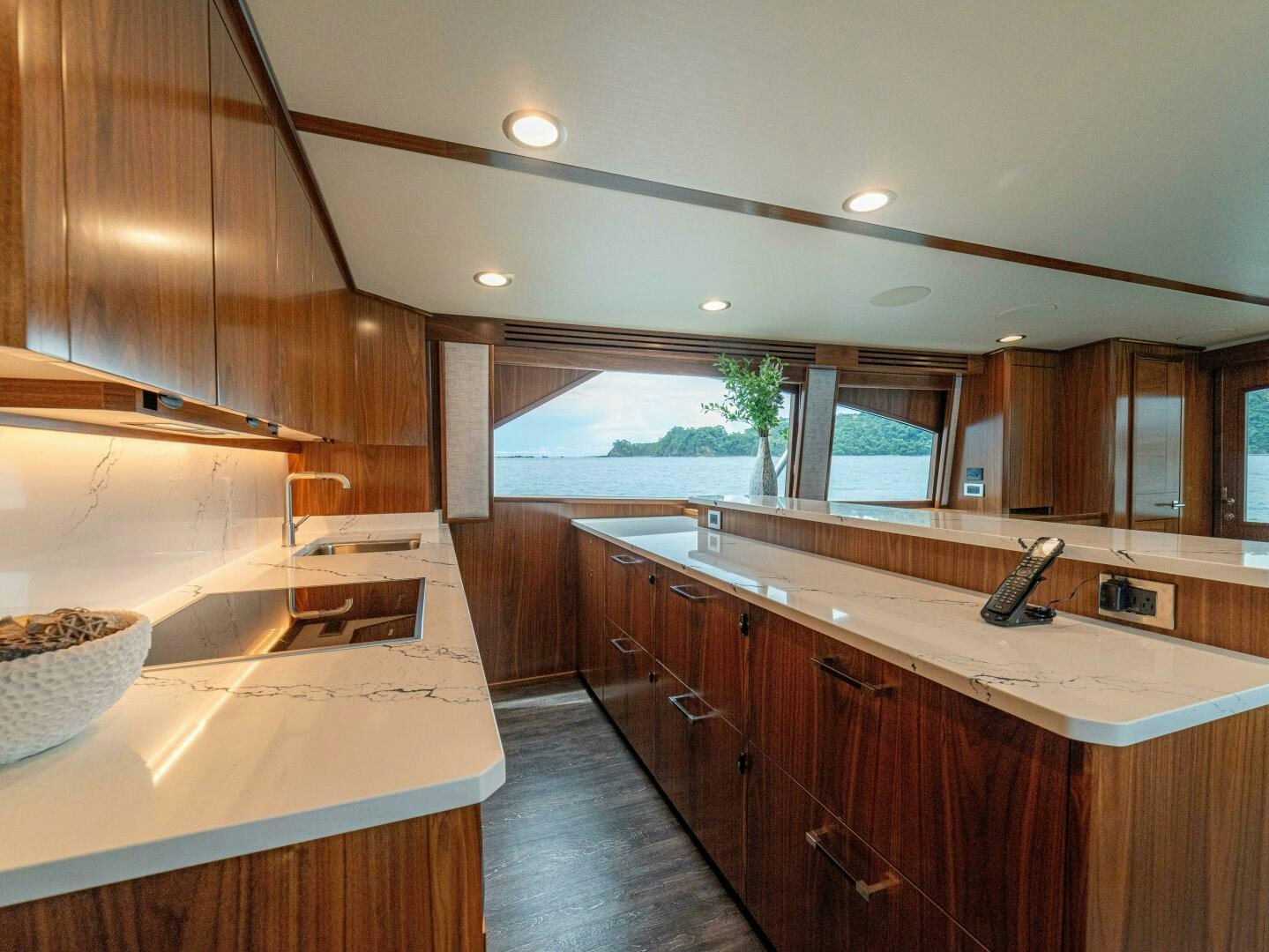 a kitchen with wooden cabinets aboard PURA VIDA Yacht for Sale