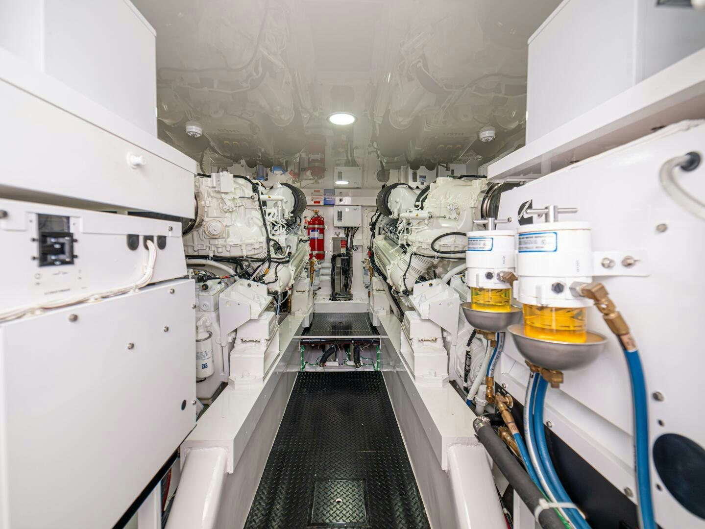 a long hallway with machinery aboard PURA VIDA Yacht for Sale