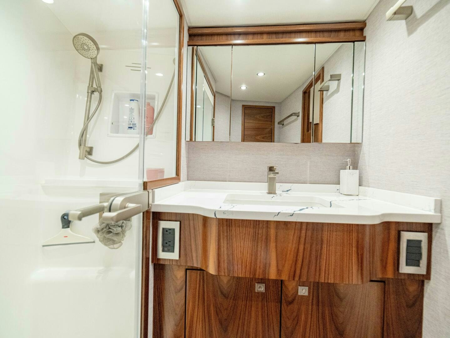 a bathroom with a mirror and a sink aboard PURA VIDA Yacht for Sale
