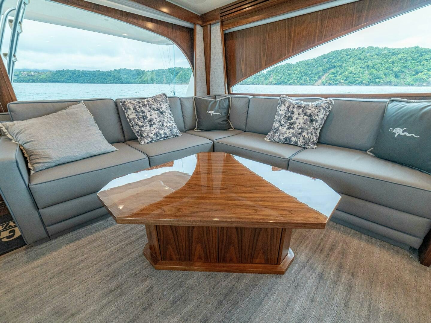 a living room with a couch and a coffee table aboard PURA VIDA Yacht for Sale
