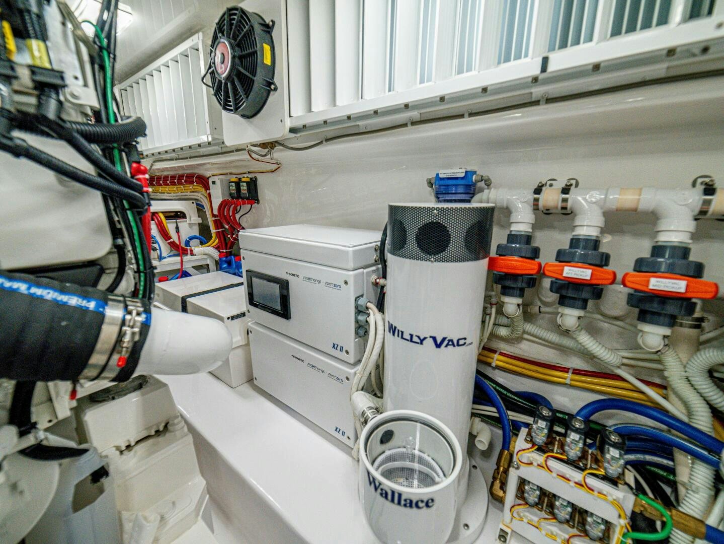 a white machine with a blue label aboard PURA VIDA Yacht for Sale