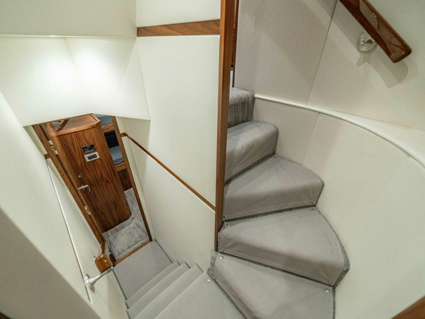 a staircase with a chair aboard PURA VIDA Yacht for Sale