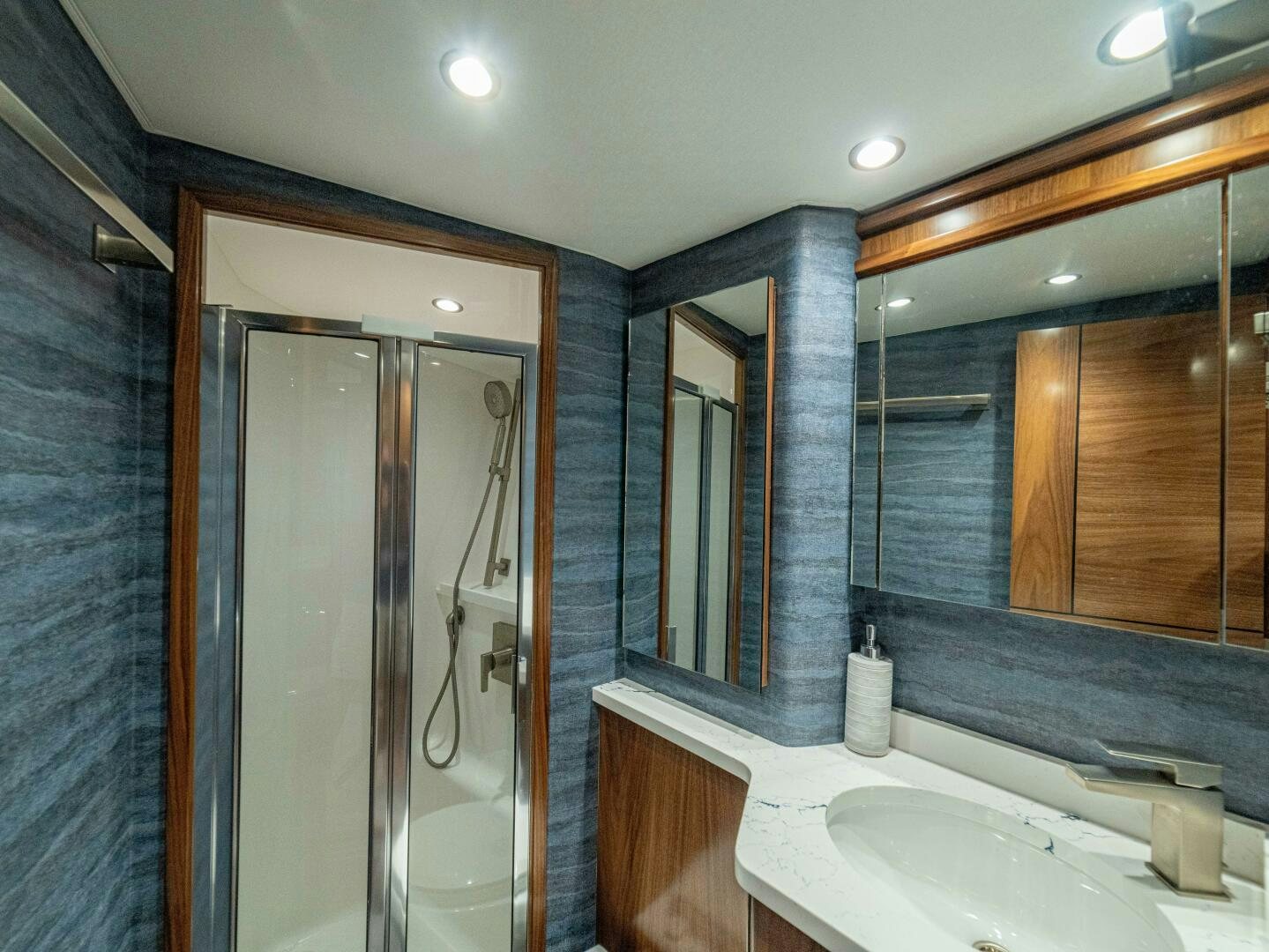 a bathroom with a sink and a shower unit aboard PURA VIDA Yacht for Sale