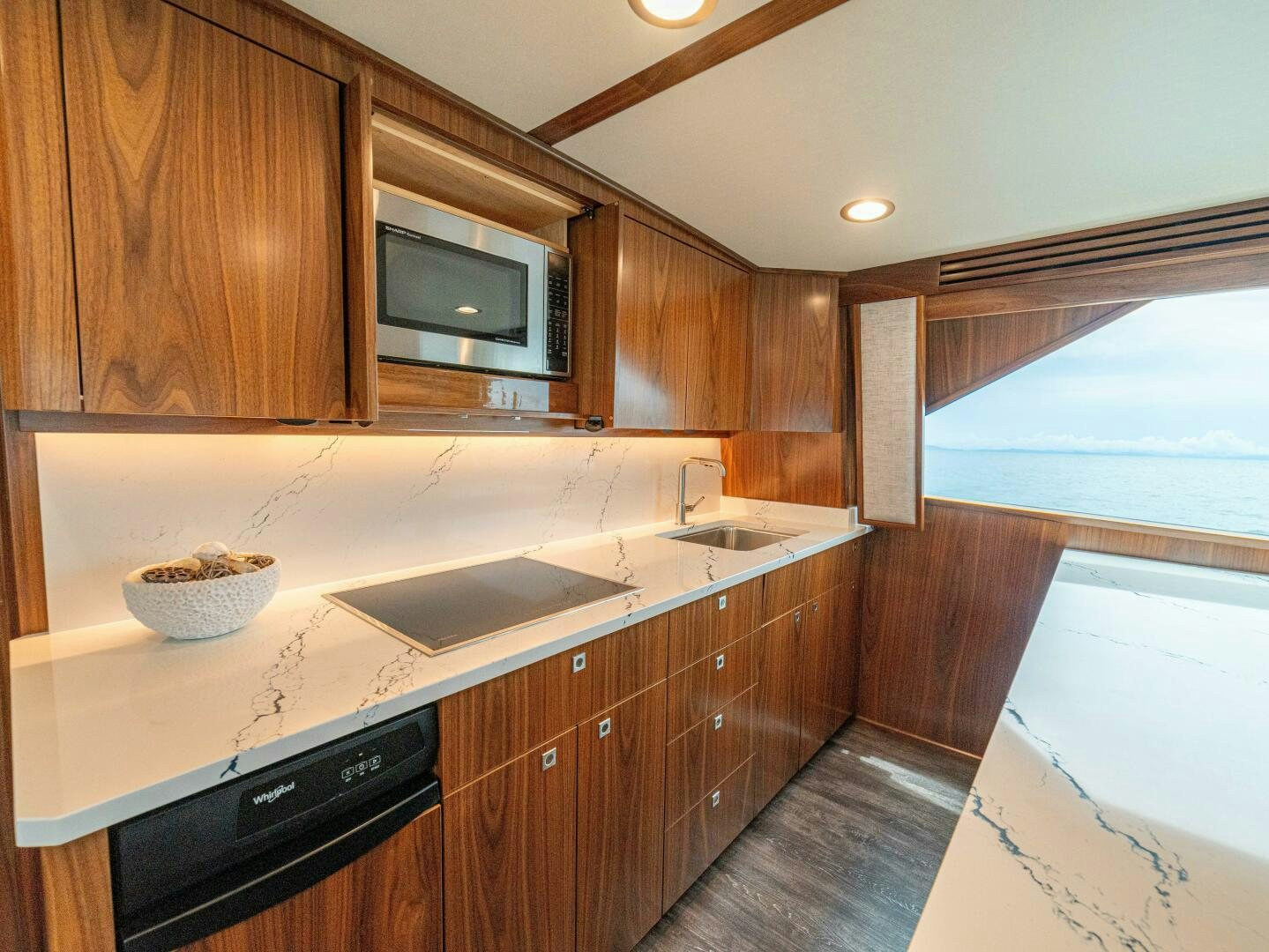 a kitchen with wooden cabinets aboard PURA VIDA Yacht for Sale