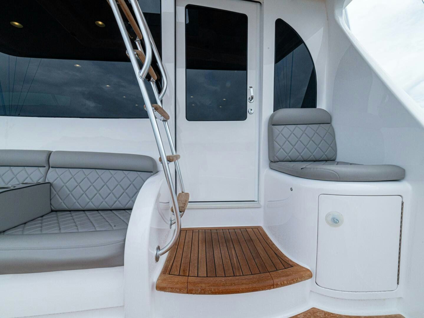 a white boat with a wooden dock aboard PURA VIDA Yacht for Sale