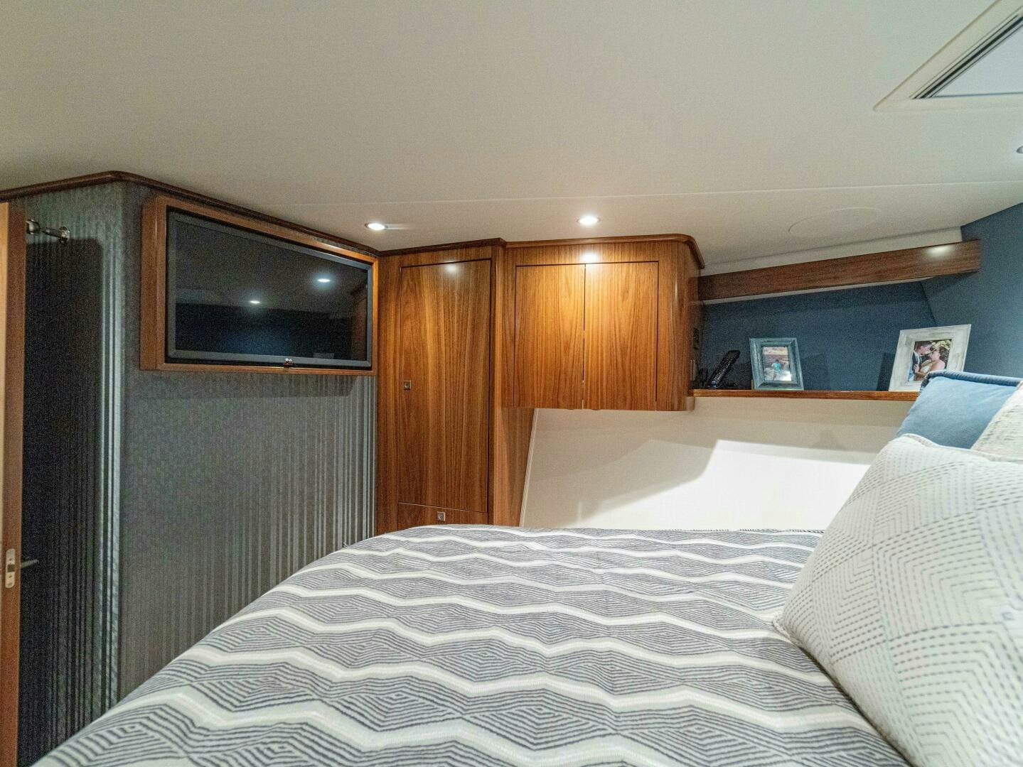 a bed with white sheets aboard PURA VIDA Yacht for Sale