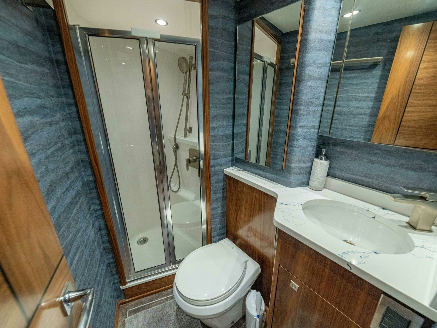 a bathroom with a glass shower door aboard PURA VIDA Yacht for Sale