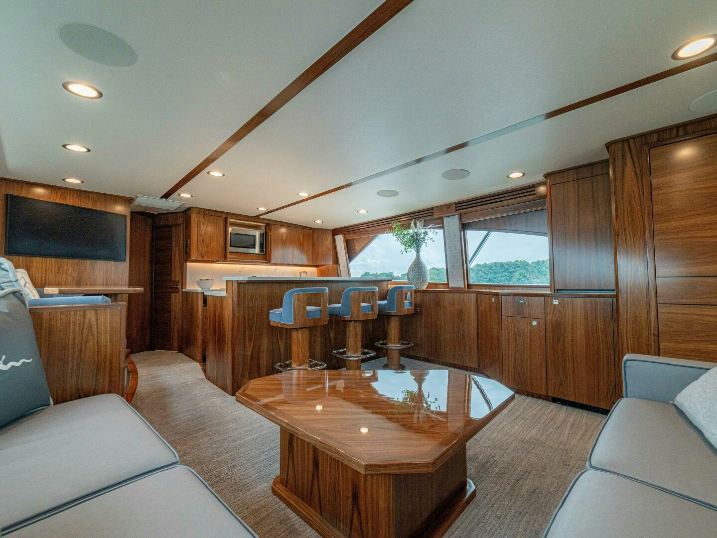 a living room with a wood table aboard PURA VIDA Yacht for Sale