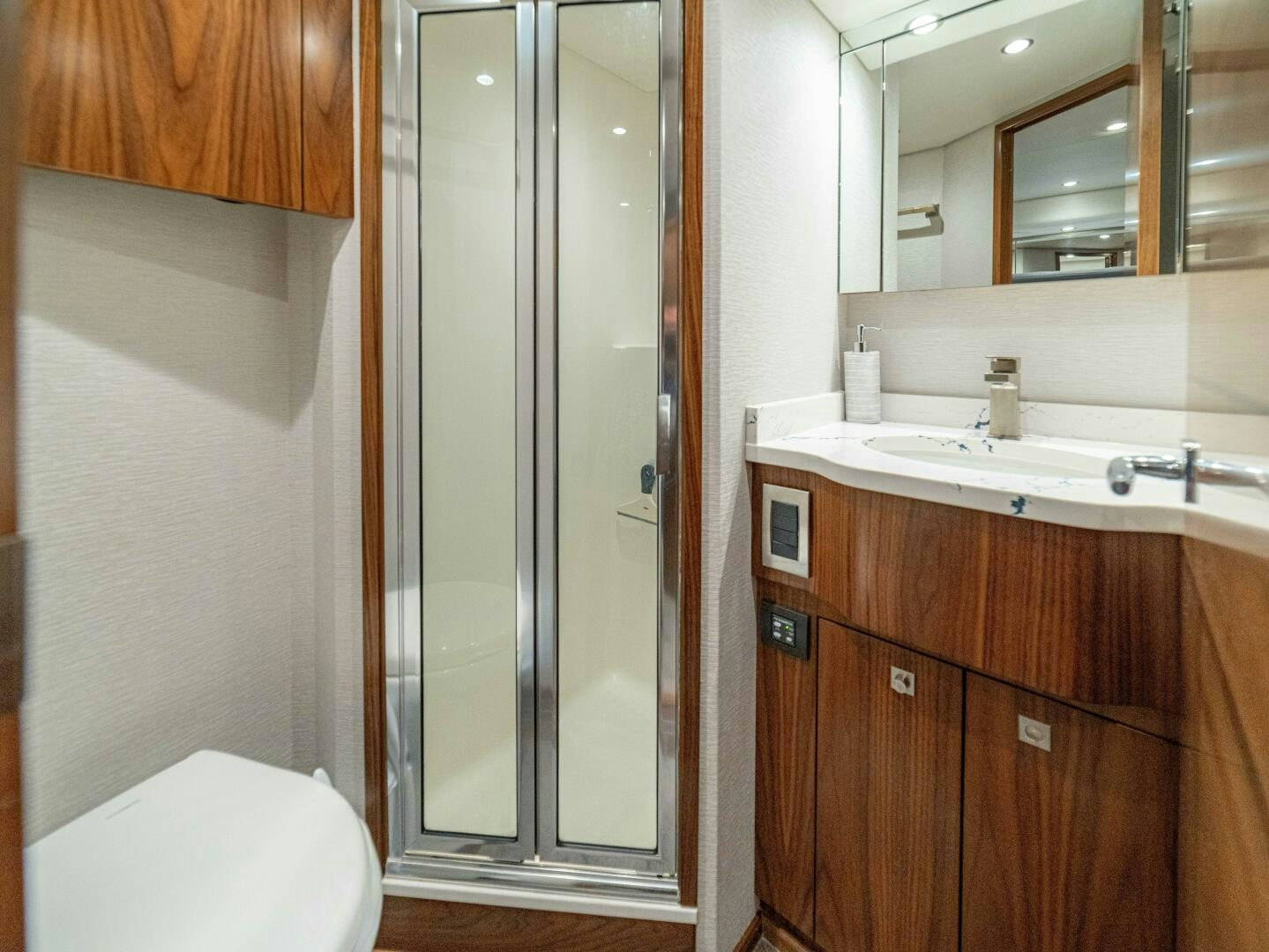 a bathroom with a glass shower aboard PURA VIDA Yacht for Sale