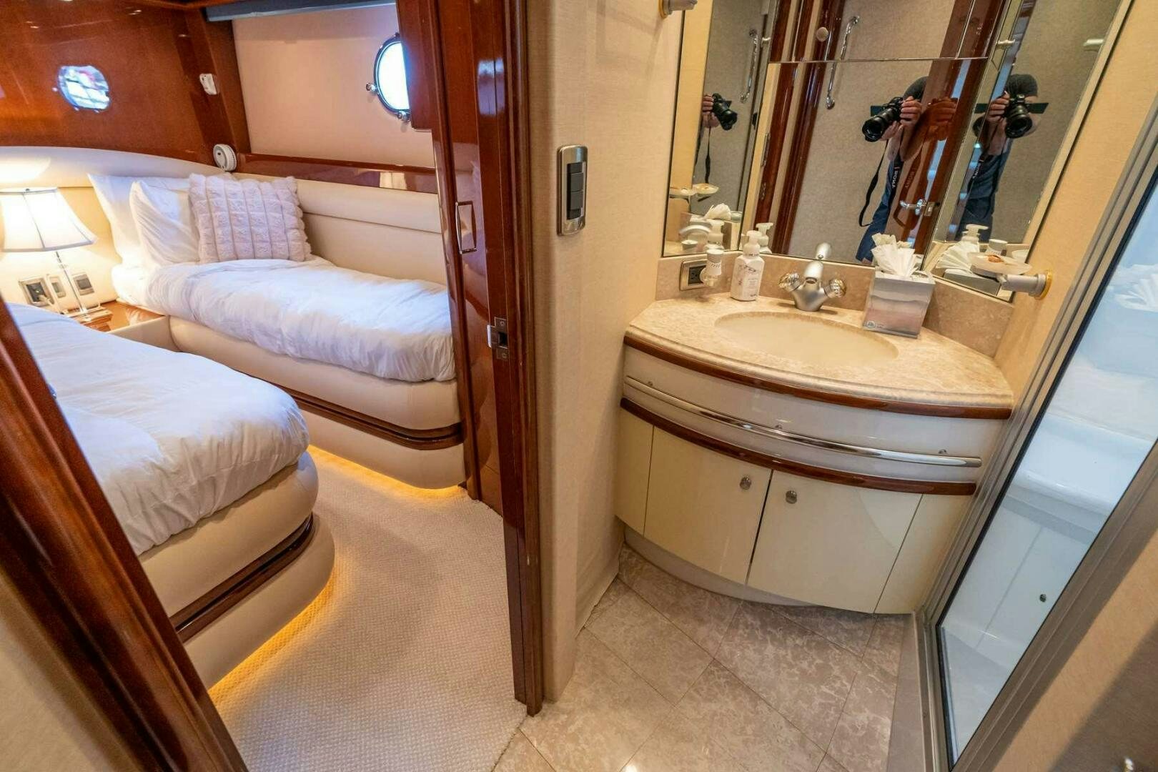 a bathroom with a sink and a bed aboard NAVETTE Yacht for Sale