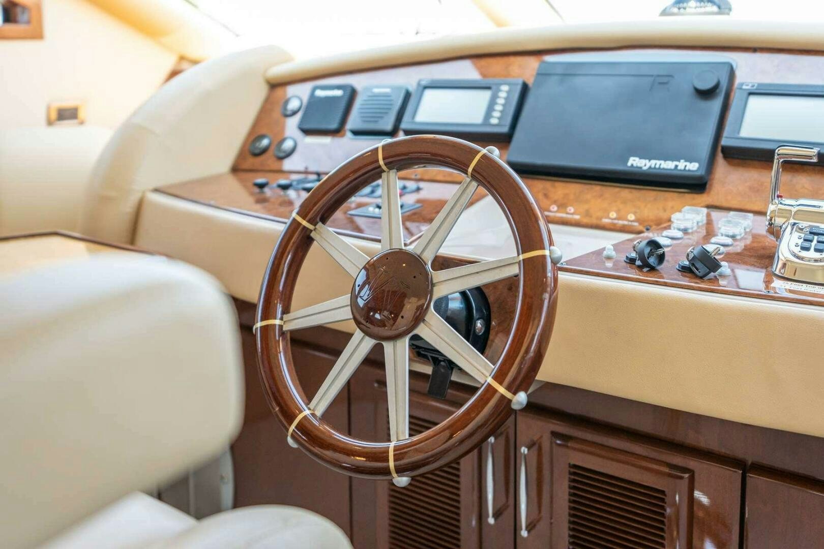 a brown leather car with a steering wheel and a black screen aboard NAVETTE Yacht for Sale