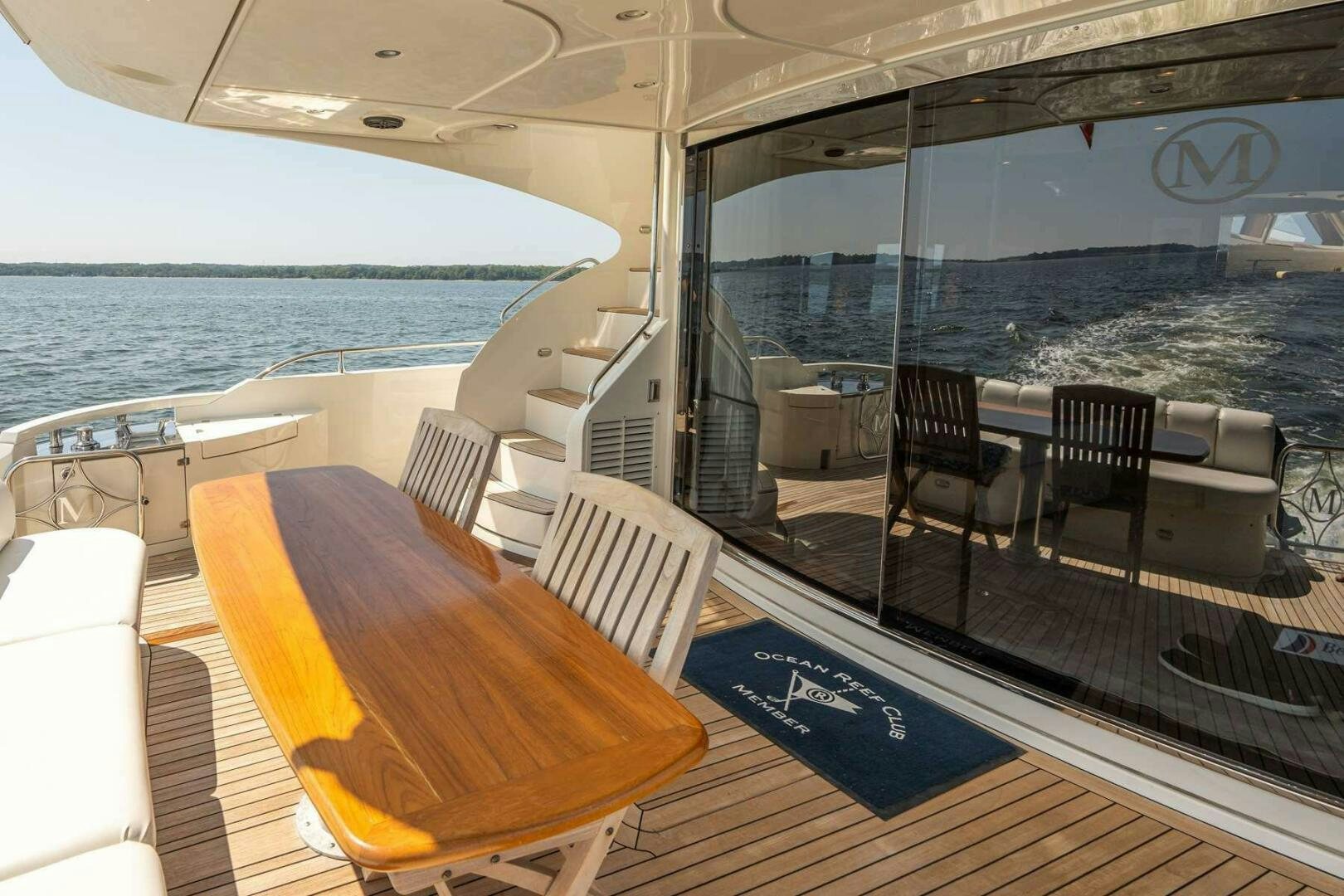a deck with a table and chairs on it aboard NAVETTE Yacht for Sale