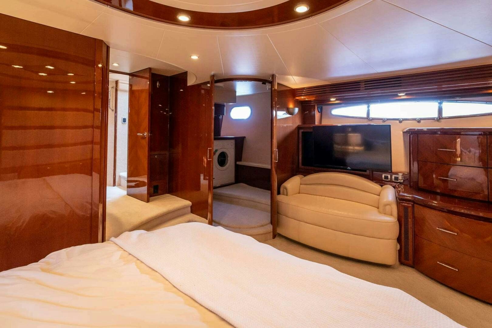 a room with a bed and a dresser aboard NAVETTE Yacht for Sale