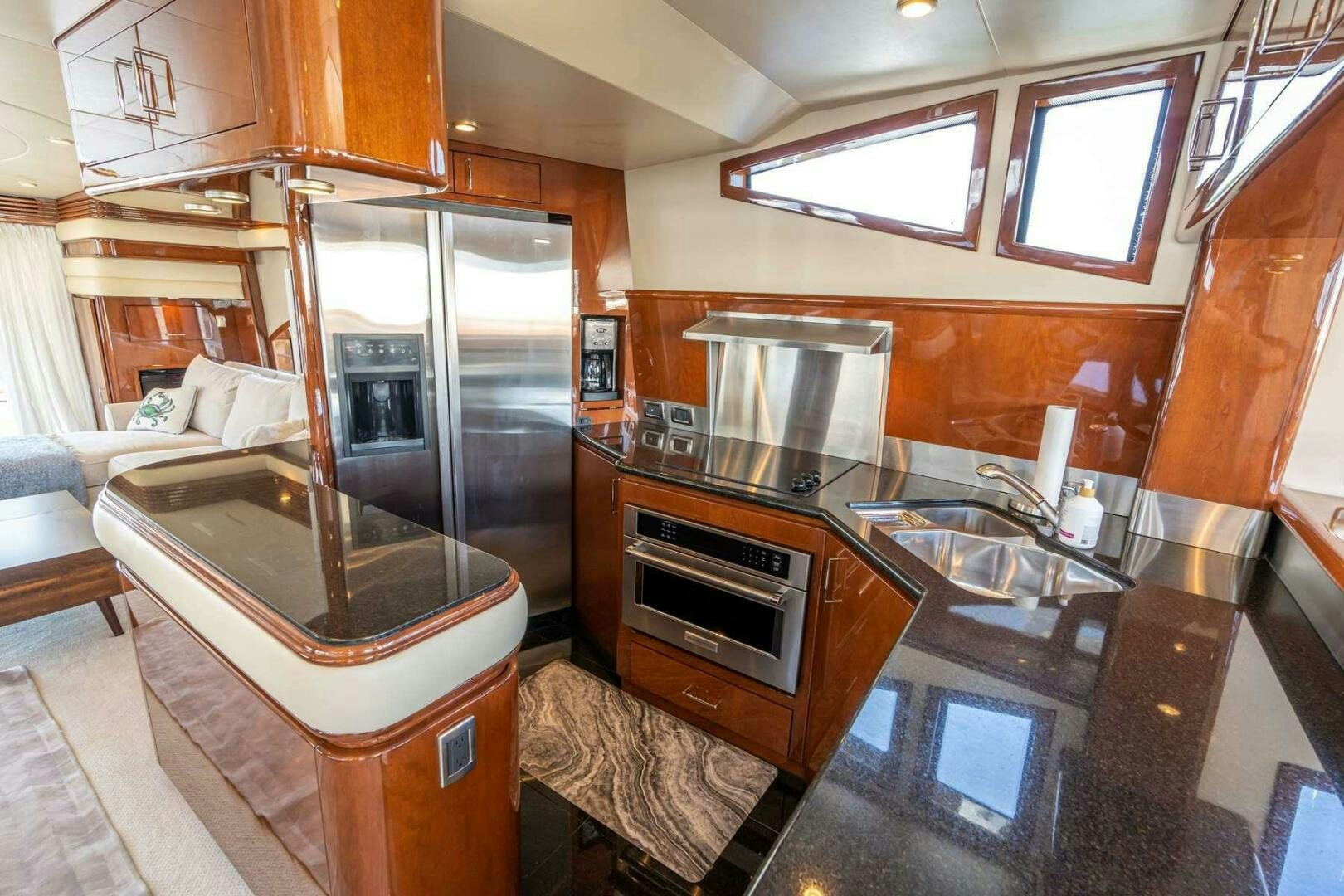 a kitchen with wooden cabinets aboard NAVETTE Yacht for Sale