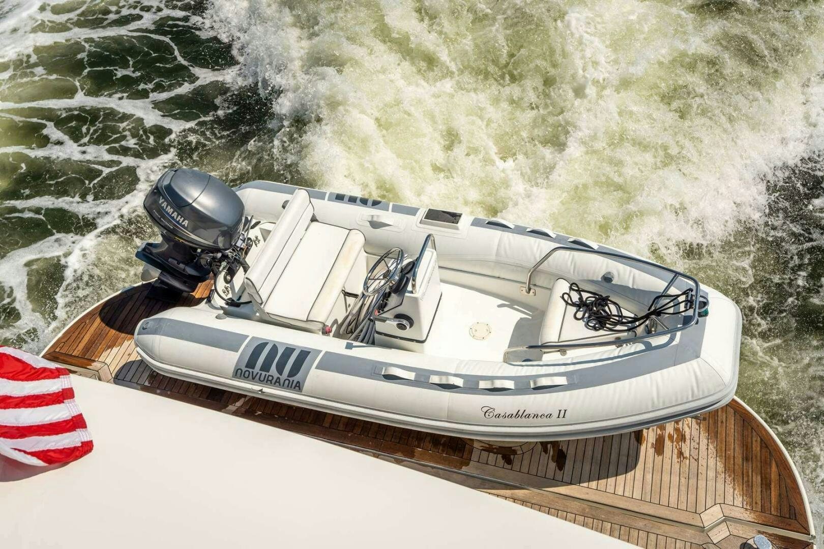 a white boat with a helmet on it aboard NAVETTE Yacht for Sale