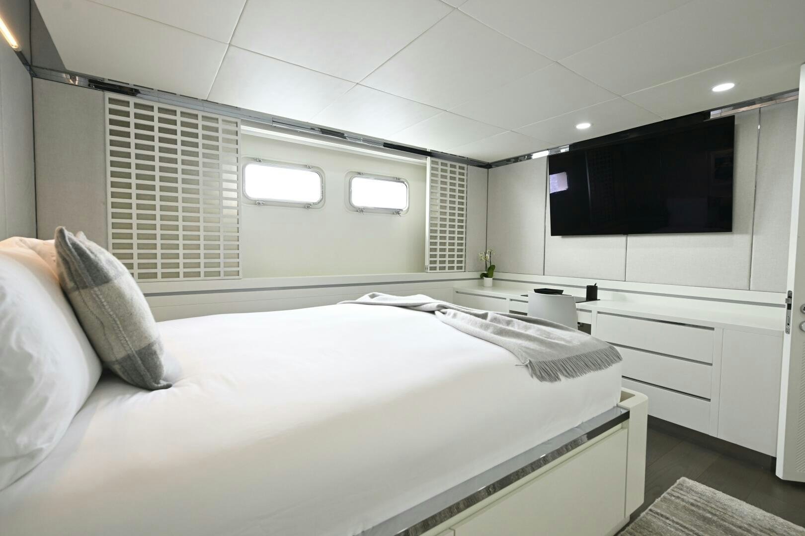 a bedroom with a bed and a sink aboard BG Yacht for Sale
