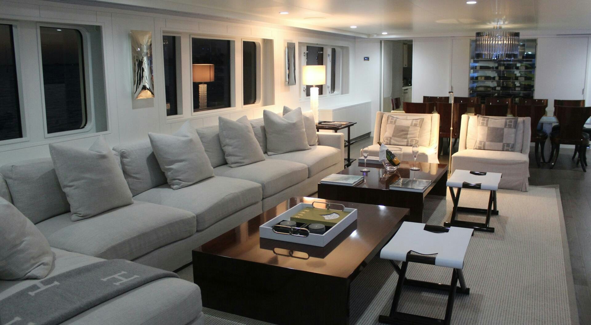 a living room with a white couch and a coffee table aboard BG Yacht for Sale