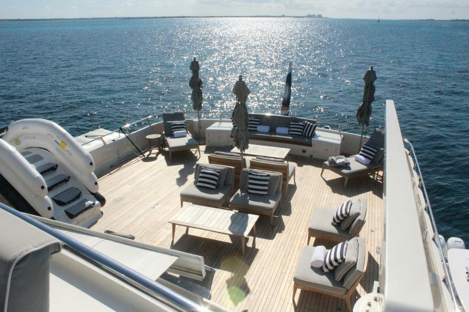 a deck with chairs and a group of people on it aboard BG Yacht for Sale