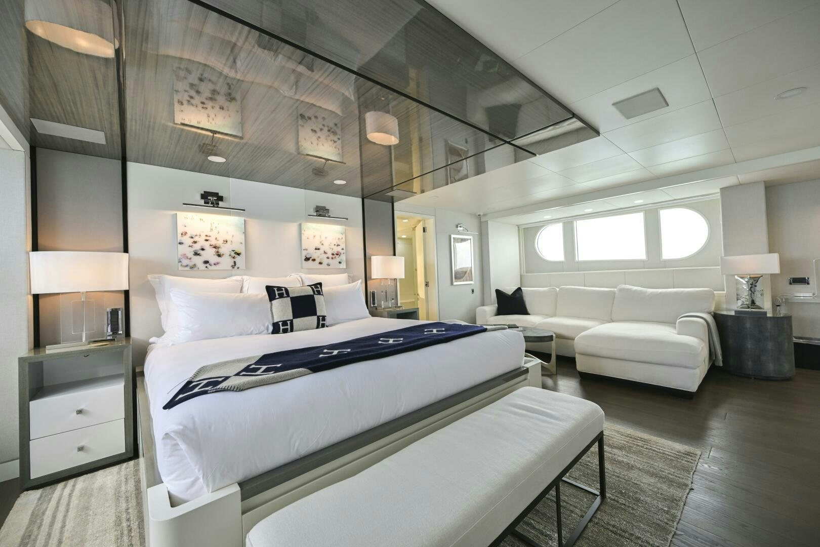 a room with a bed and a couch aboard BG Yacht for Sale