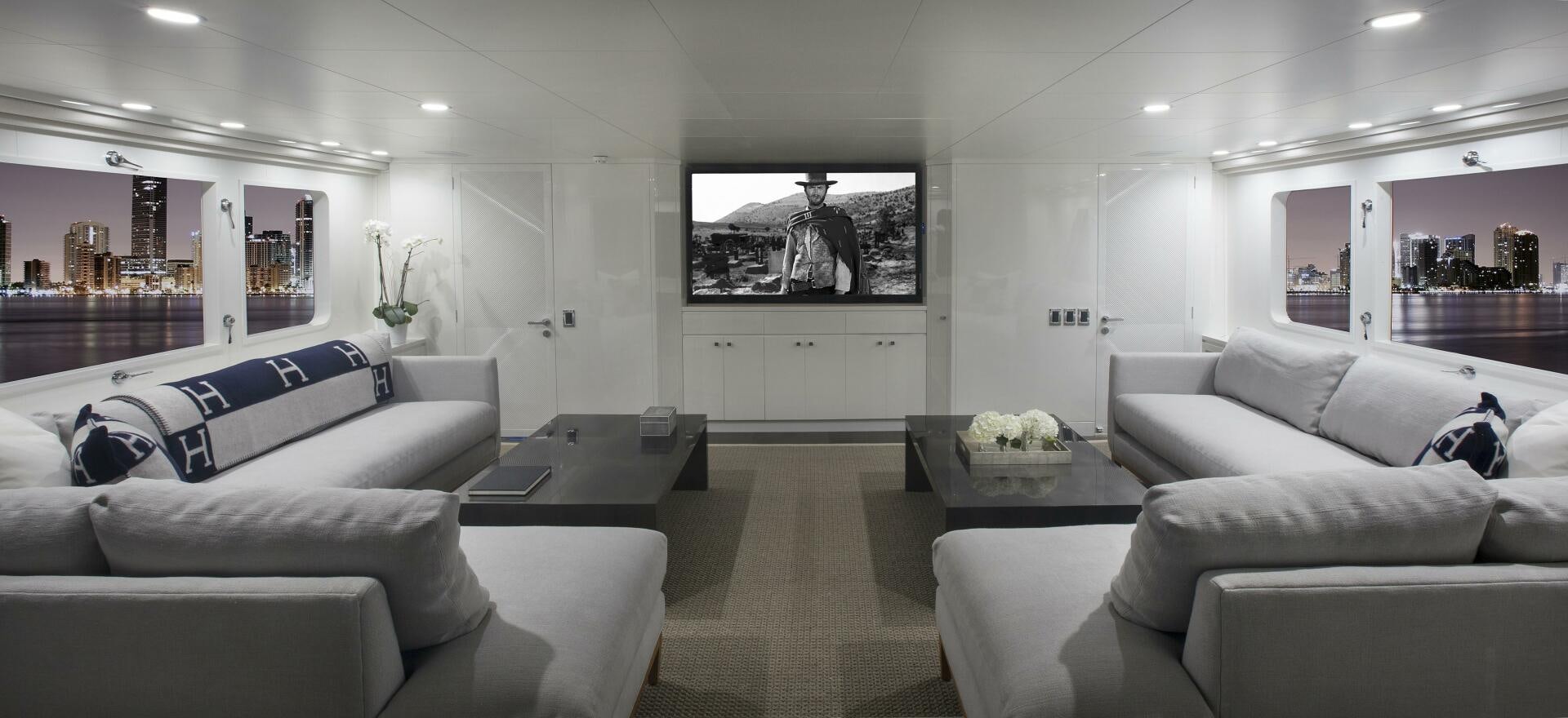 a living room with white couches aboard BG Yacht for Sale