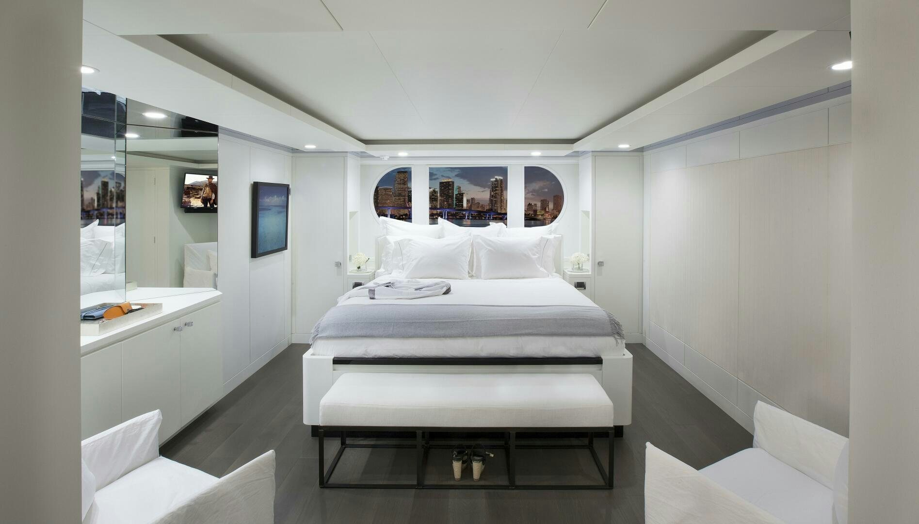 a room with a bed and a desk aboard BG Yacht for Sale