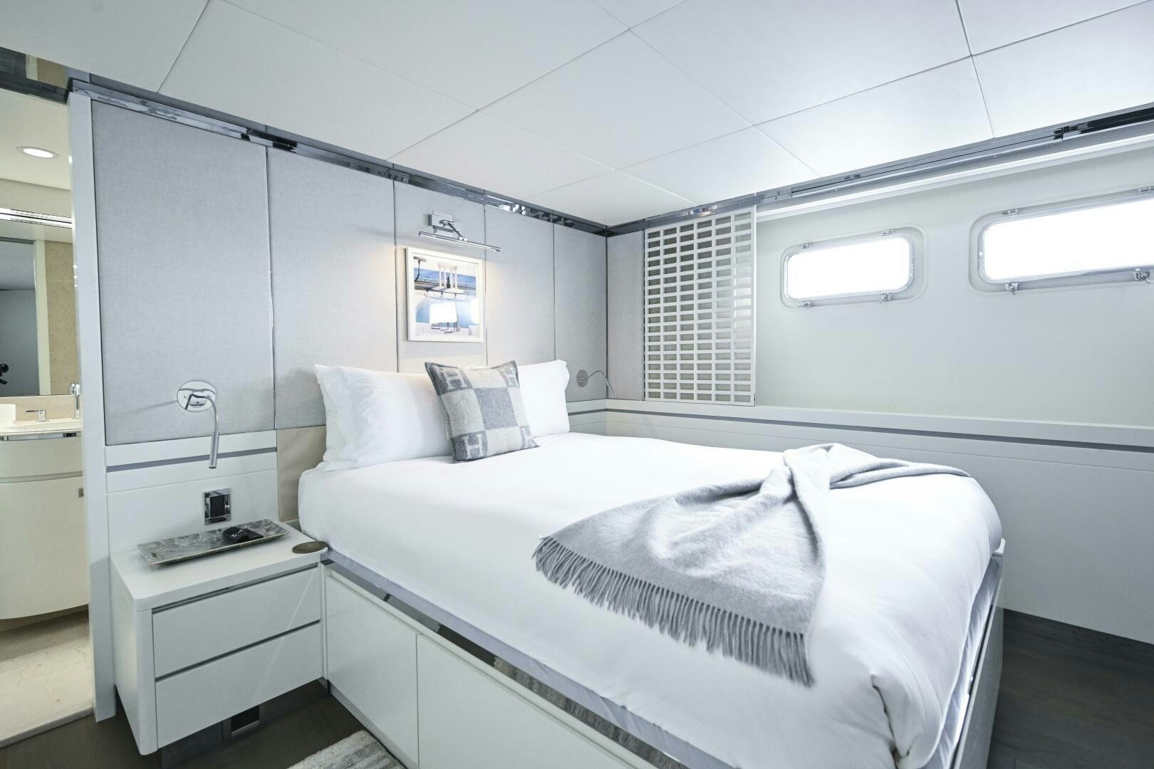 a white bedroom with a bed aboard BG Yacht for Sale