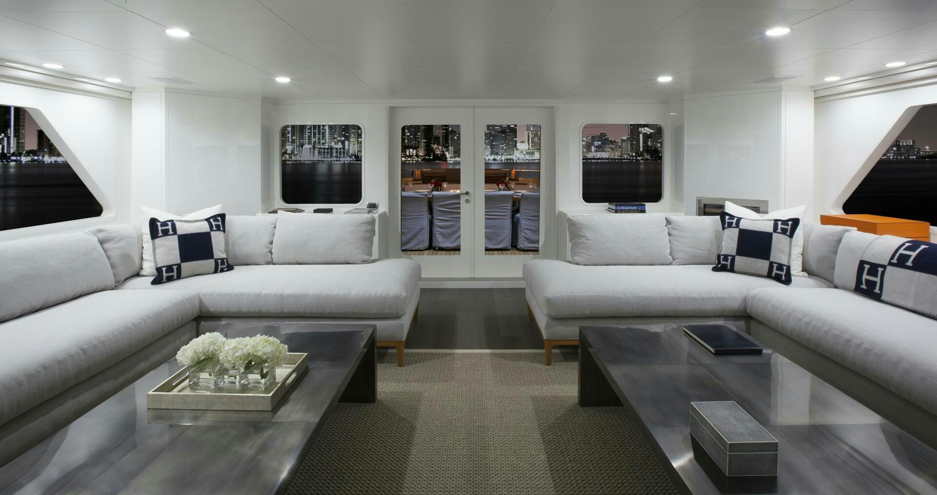 a living room with a white couch and a coffee table aboard BG Yacht for Sale