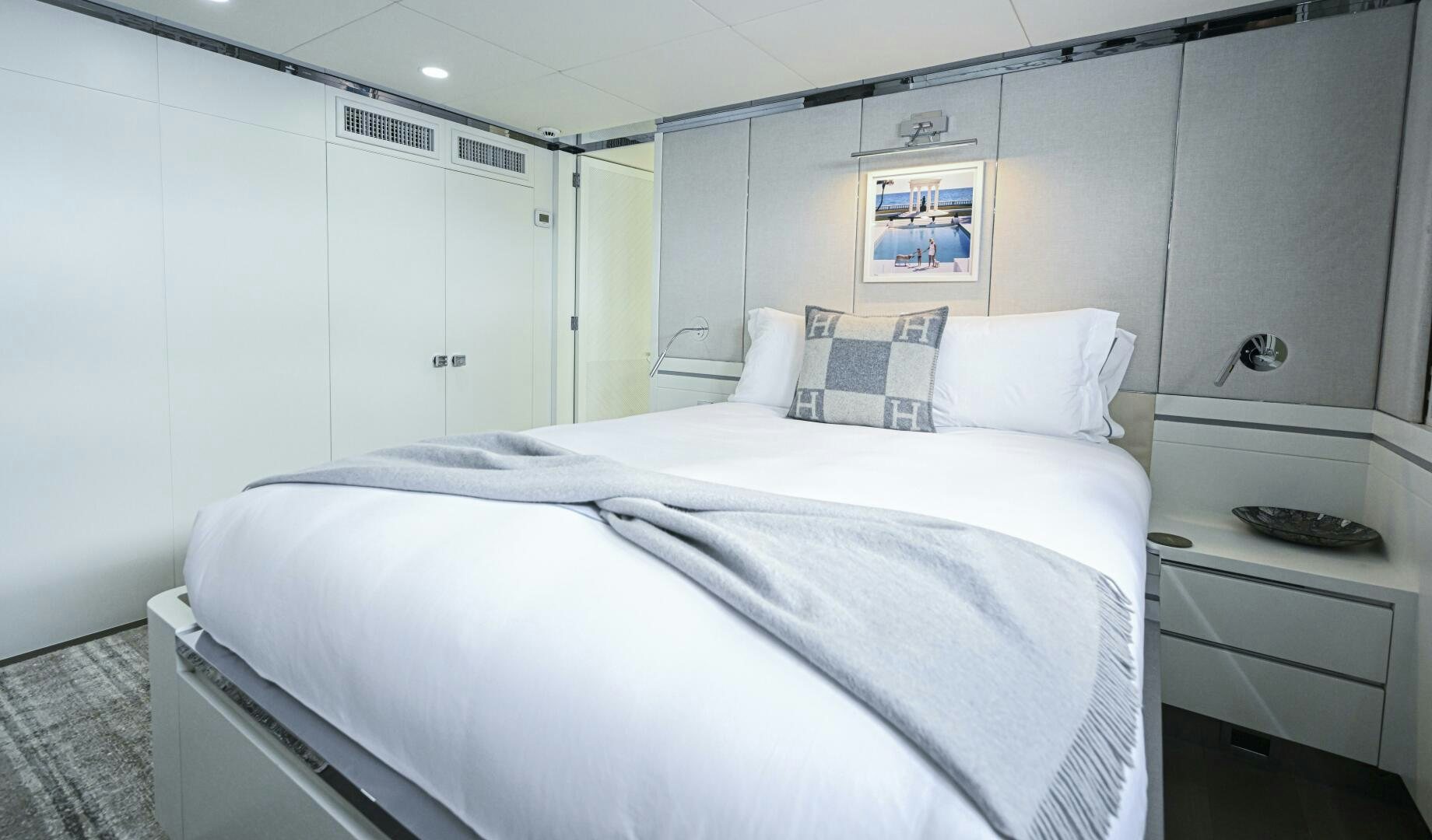 a white bedroom with a bed aboard BG Yacht for Sale