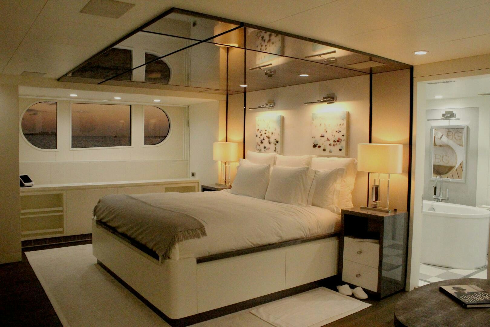 a bedroom with a bed and a desk aboard BG Yacht for Sale