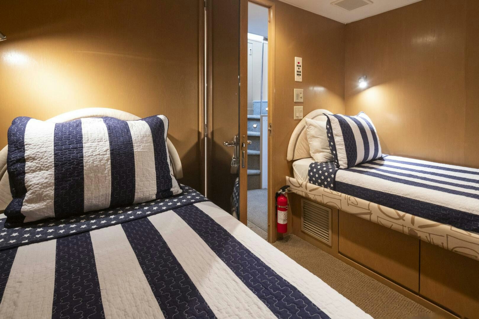 a bed with blue and white striped sheets aboard LISA SEA I Yacht for Sale