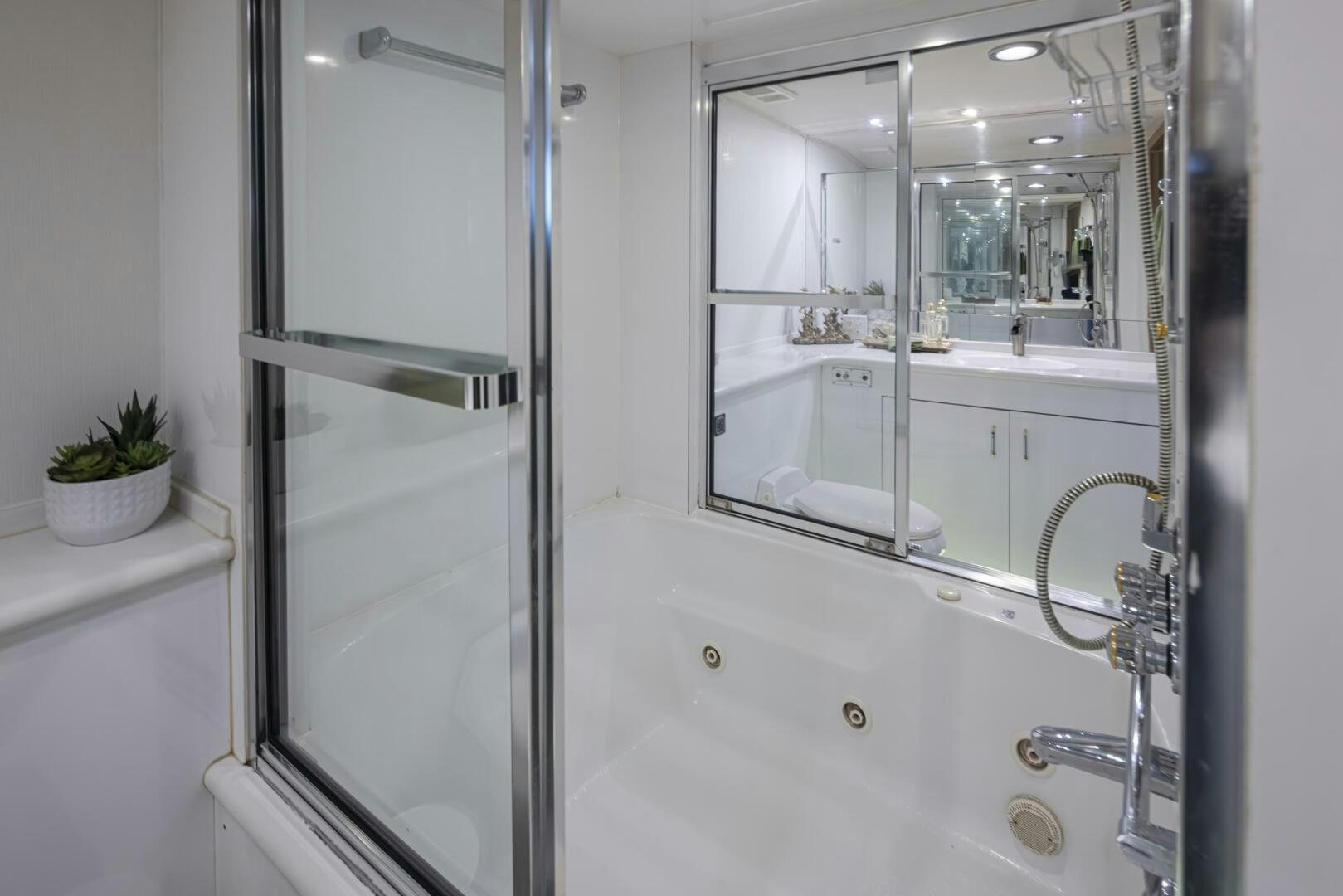 a bathroom with a tub sink and a shower unit aboard LISA SEA I Yacht for Sale