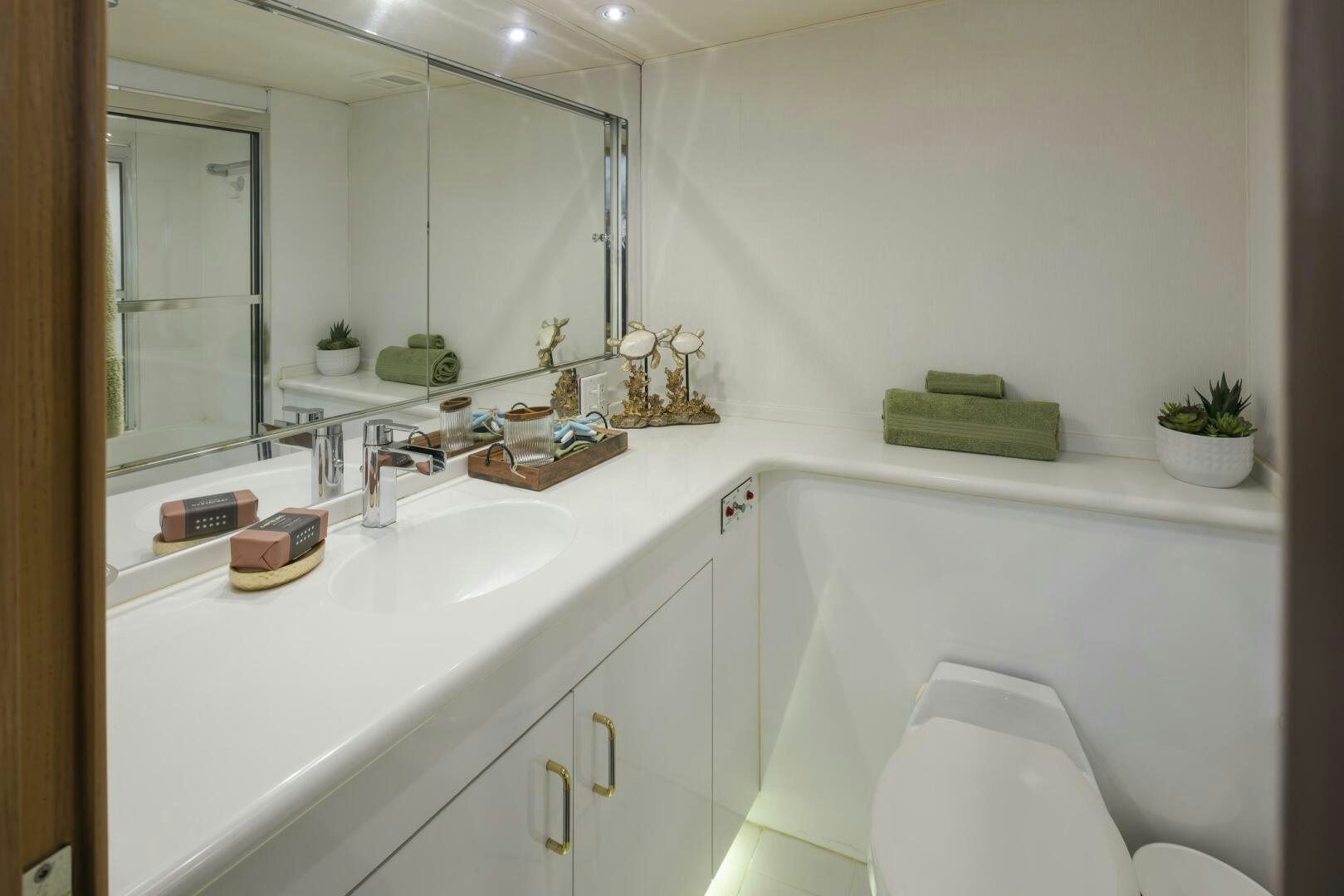 a bathroom with a tub sink and a mirror aboard LISA SEA I Yacht for Sale