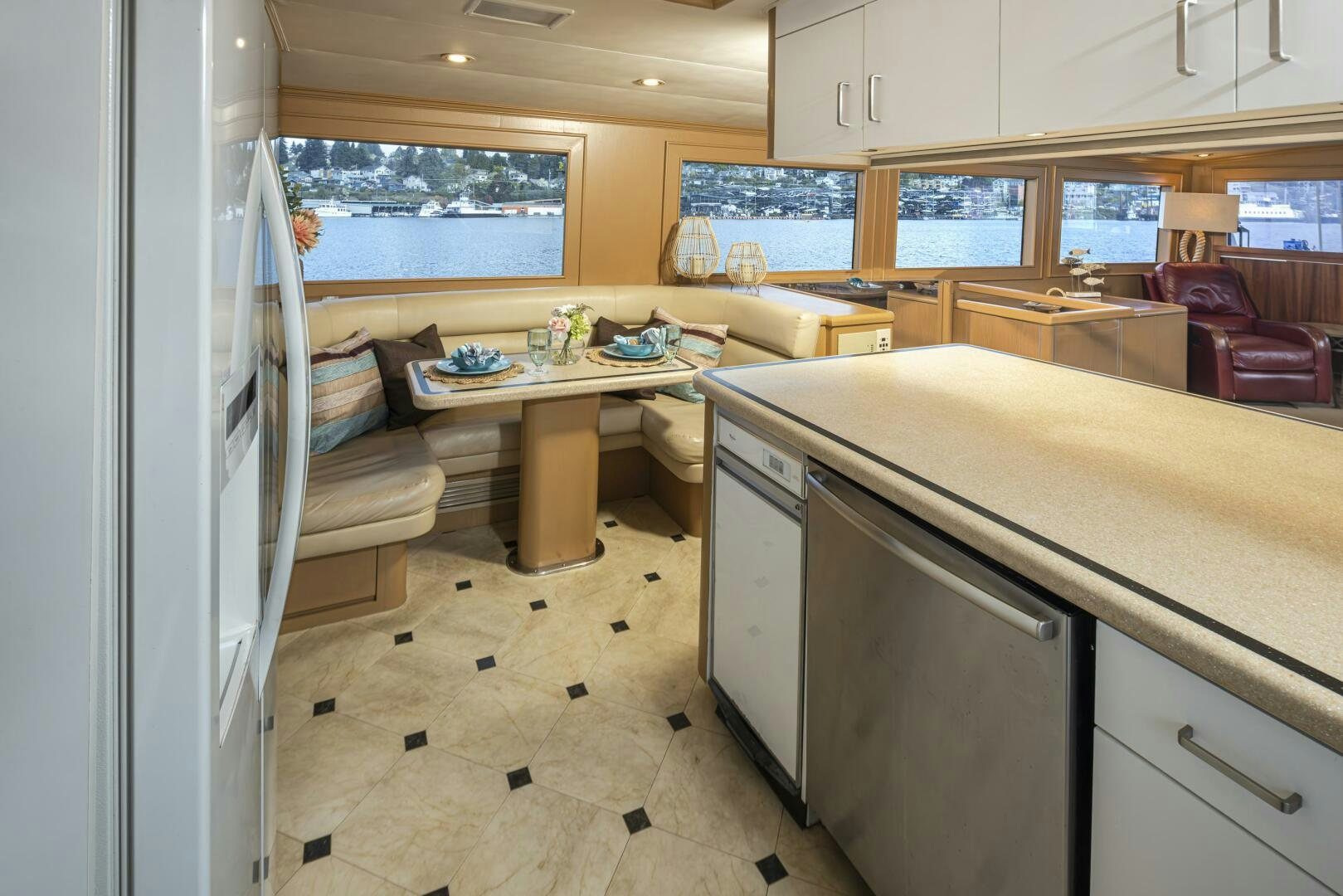 a kitchen with a table and a refrigerator aboard LISA SEA I Yacht for Sale
