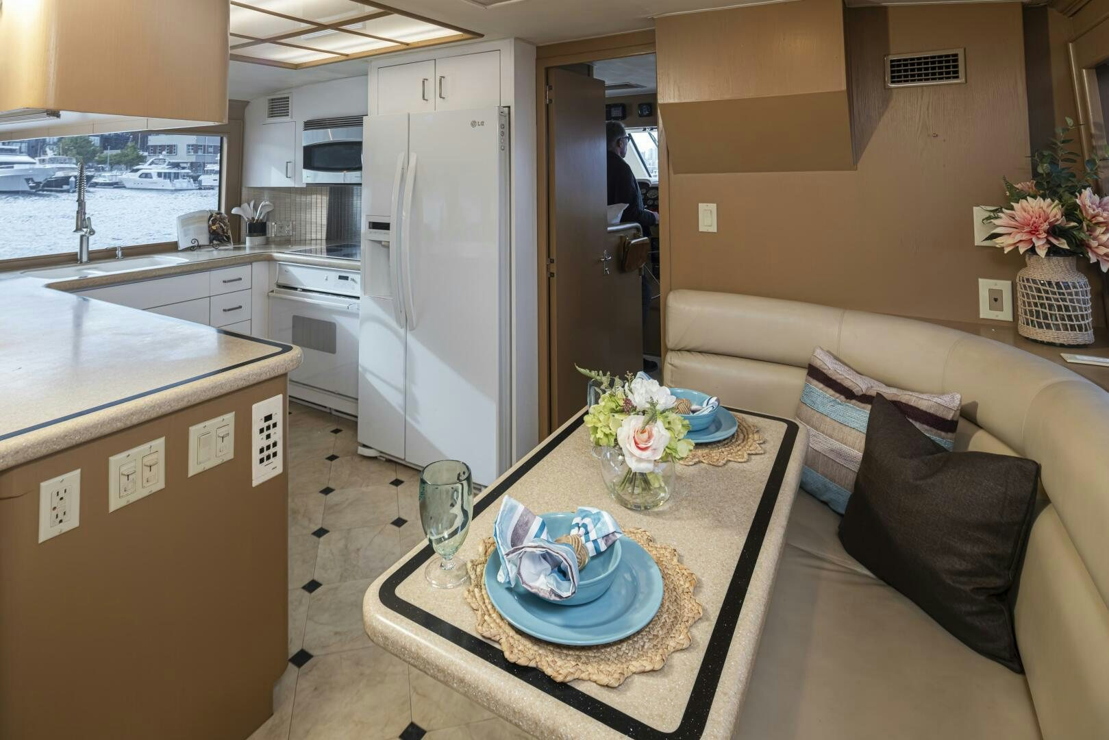 a kitchen with a table and a couch aboard LISA SEA I Yacht for Sale