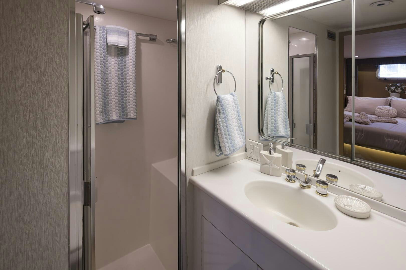 a bathroom with a sink and towels aboard LISA SEA I Yacht for Sale