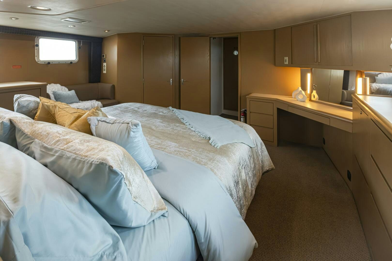 a bedroom with a bed and desk aboard LISA SEA I Yacht for Sale