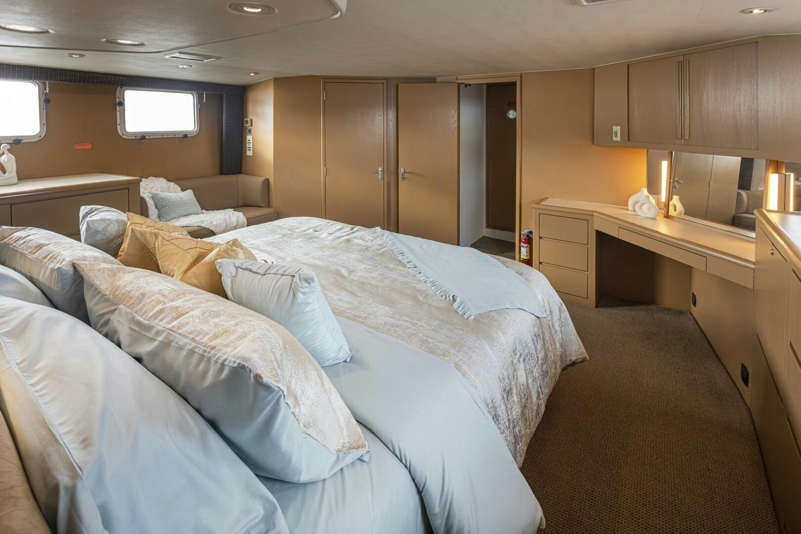 a bedroom with a bed and desk aboard LISA SEA I Yacht for Sale