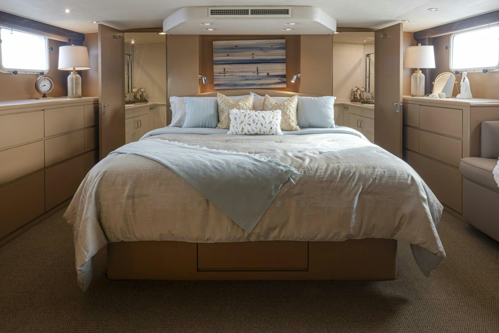 a bed with a blue comforter aboard LISA SEA I Yacht for Sale