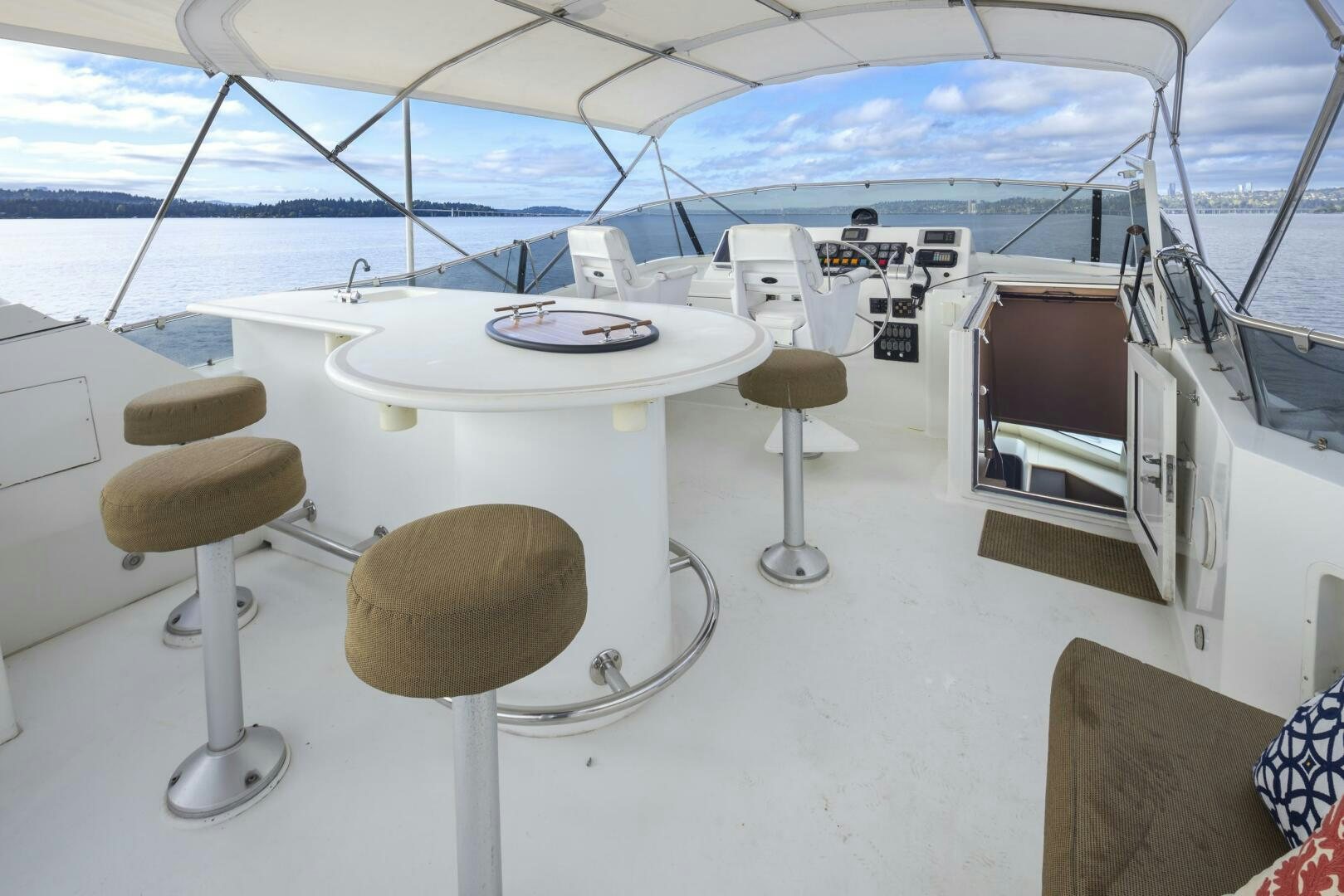a table with stools and a plate on it aboard LISA SEA I Yacht for Sale