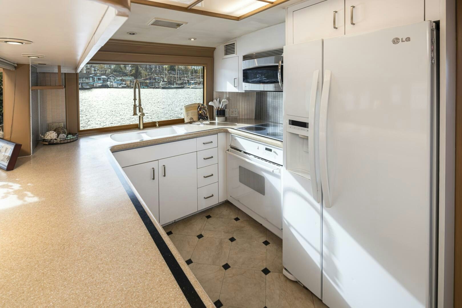 a kitchen with white appliances aboard LISA SEA I Yacht for Sale