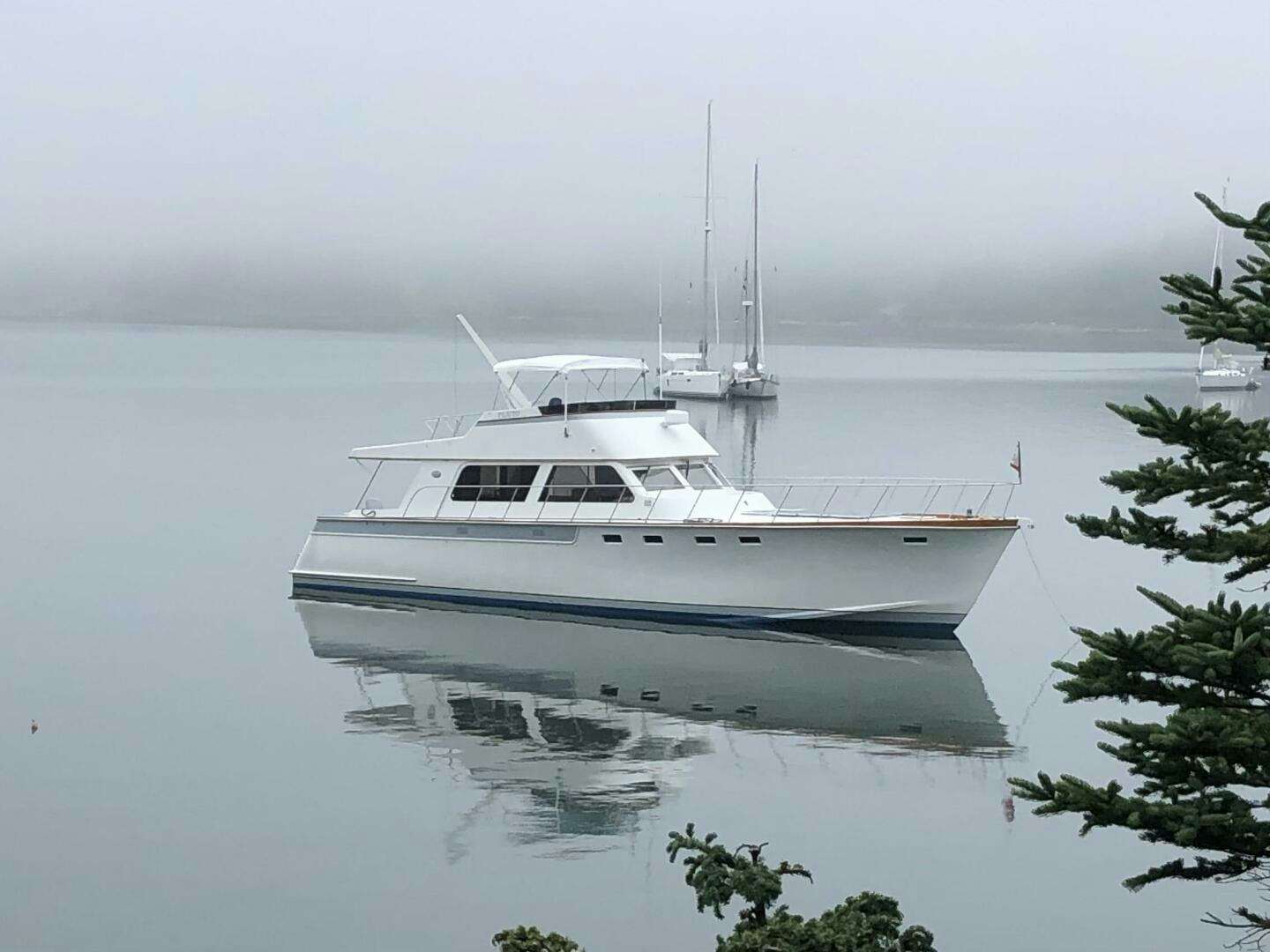 a white boat in the water aboard PLUTO Yacht for Sale