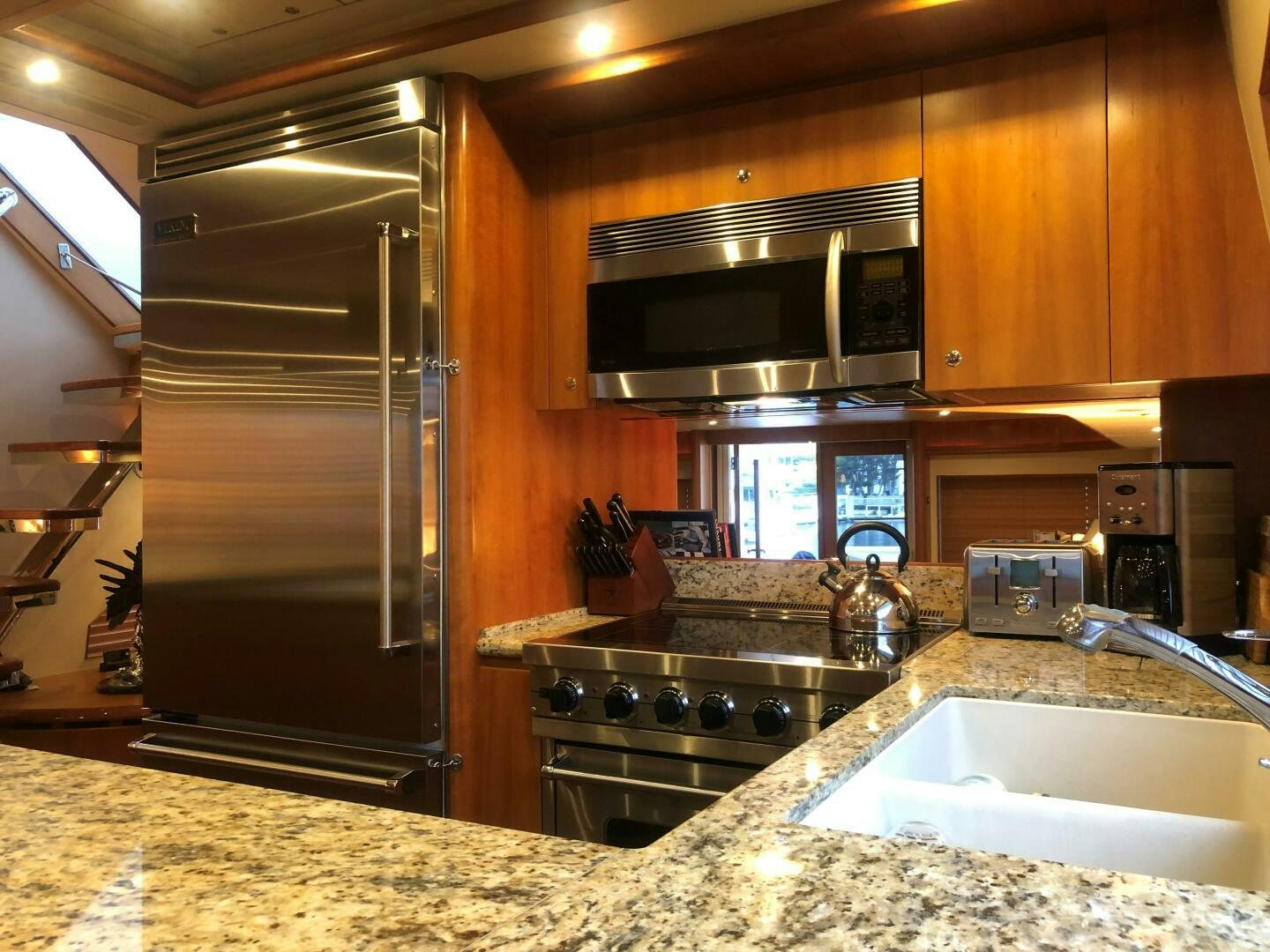 a kitchen with a stainless steel refrigerator aboard ENCHANTRESS Yacht for Sale