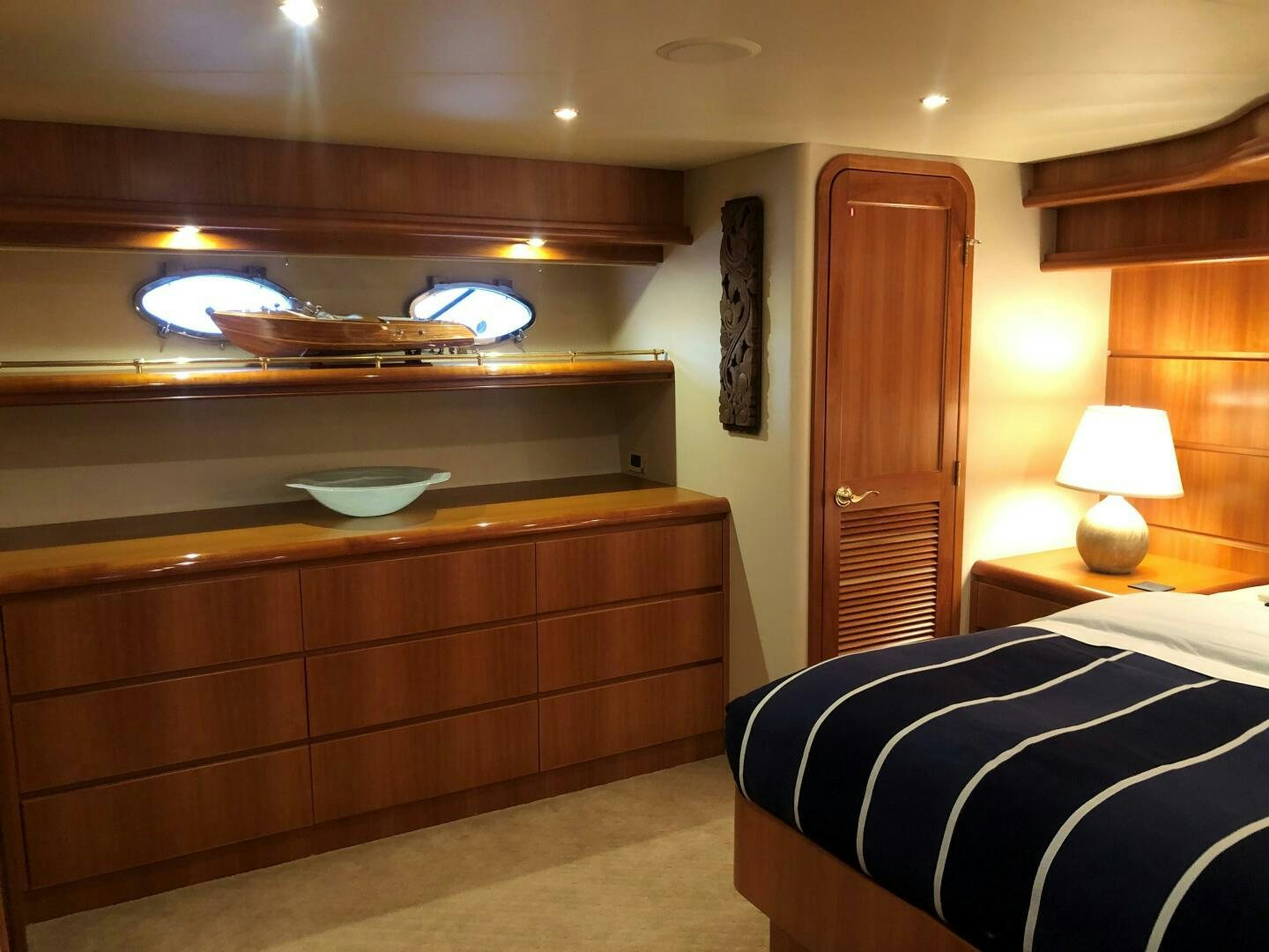 a bedroom with a wood cabinet aboard ENCHANTRESS Yacht for Sale