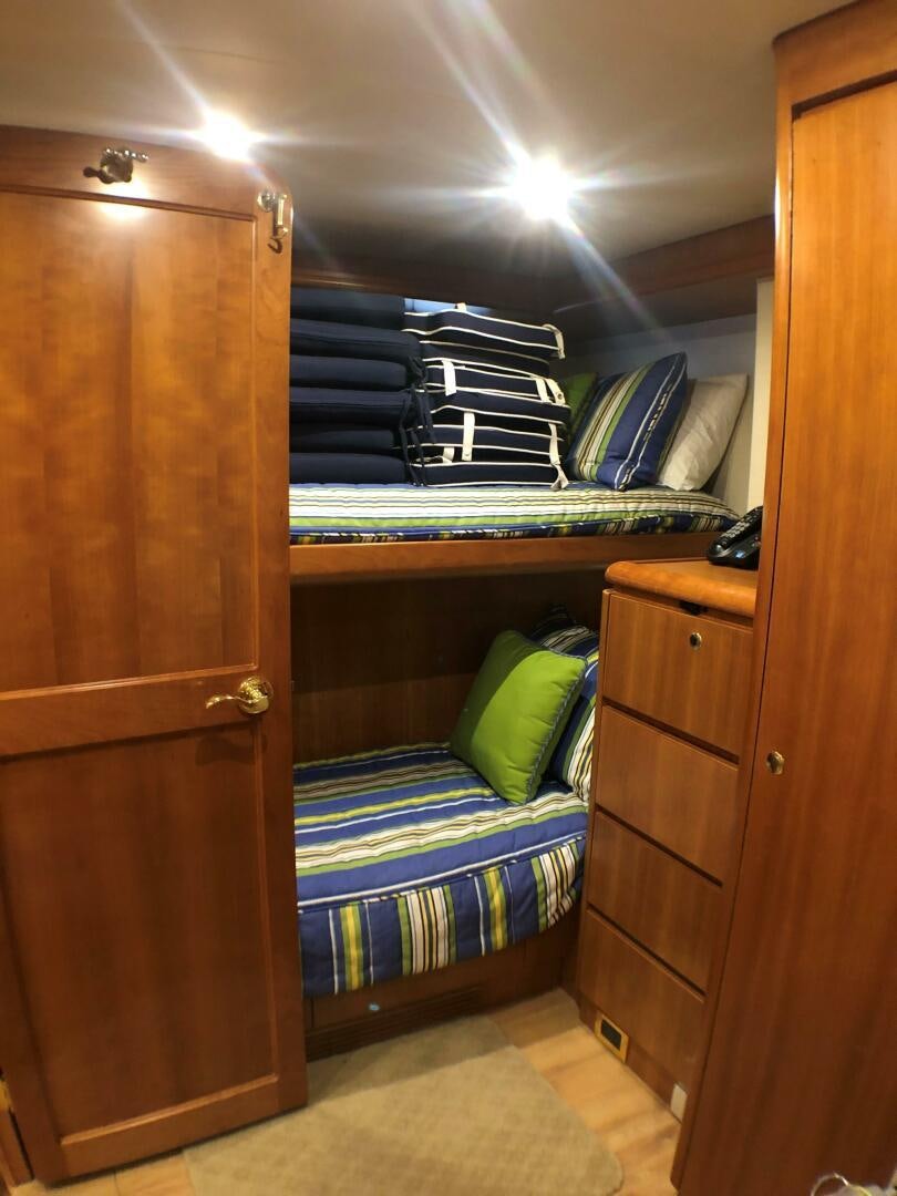 a bedroom with a closet and bunk beds aboard ENCHANTRESS Yacht for Sale