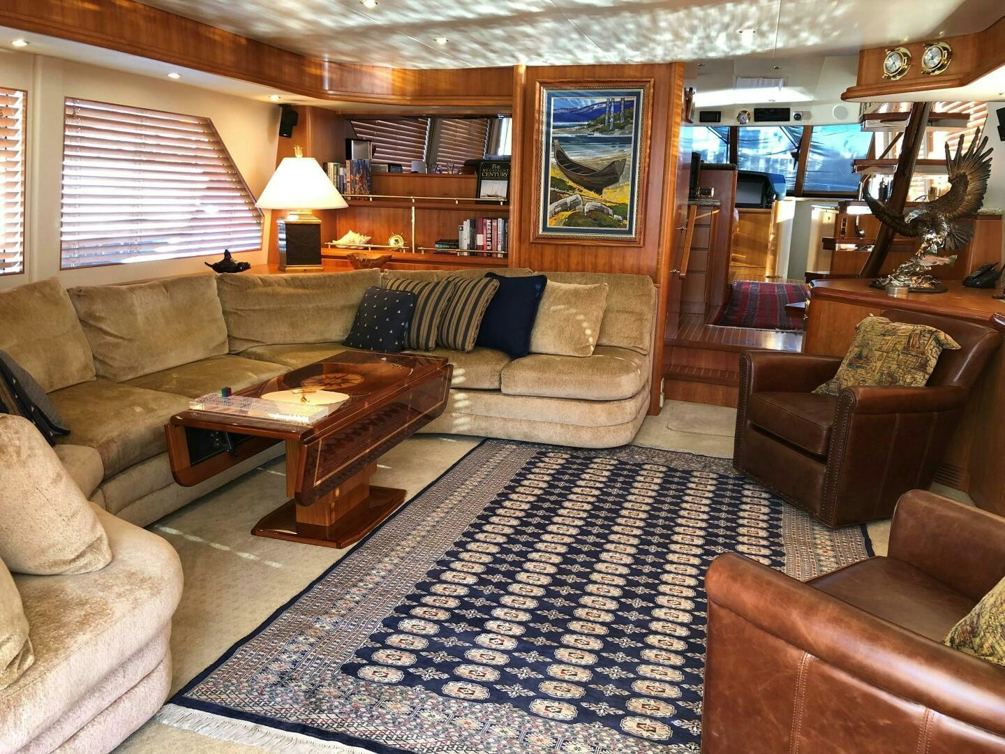 a living room with leather couches aboard ENCHANTRESS Yacht for Sale