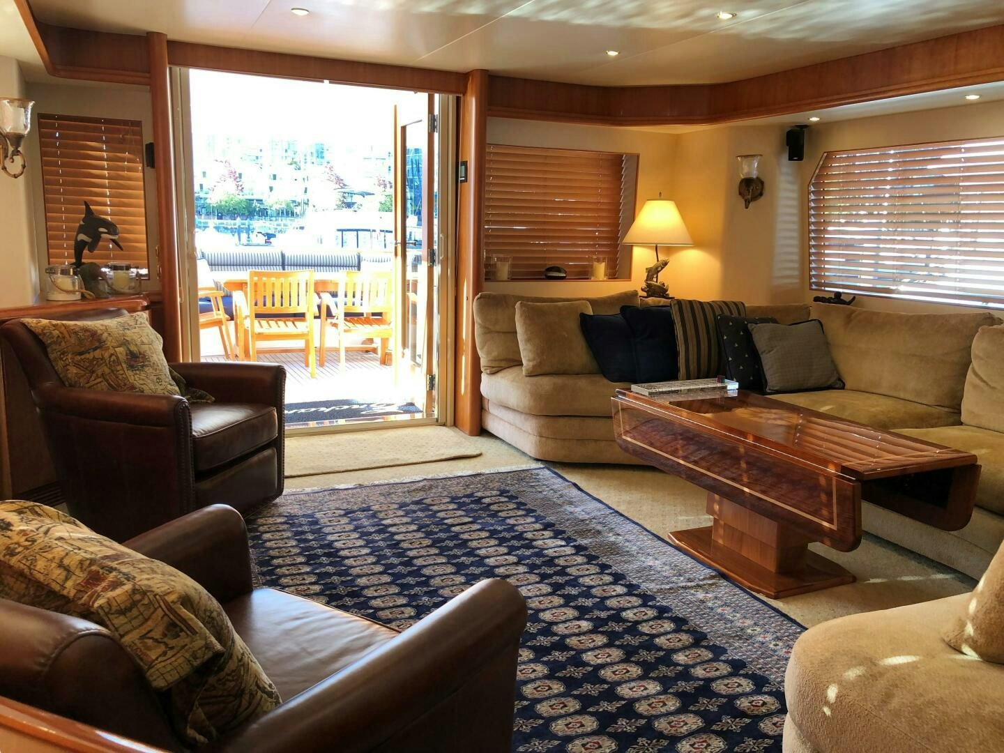 a living room with a blue rug aboard ENCHANTRESS Yacht for Sale