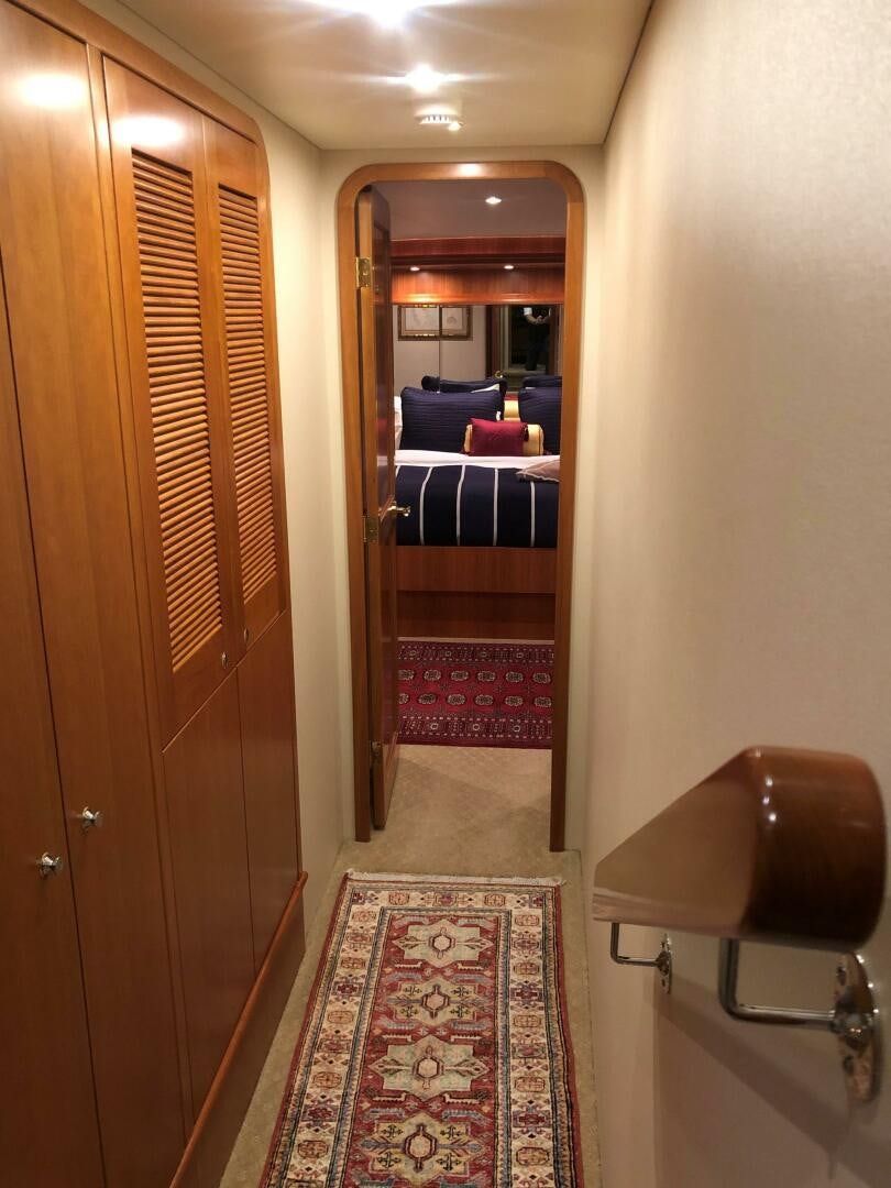 a hallway with a red rug aboard ENCHANTRESS Yacht for Sale