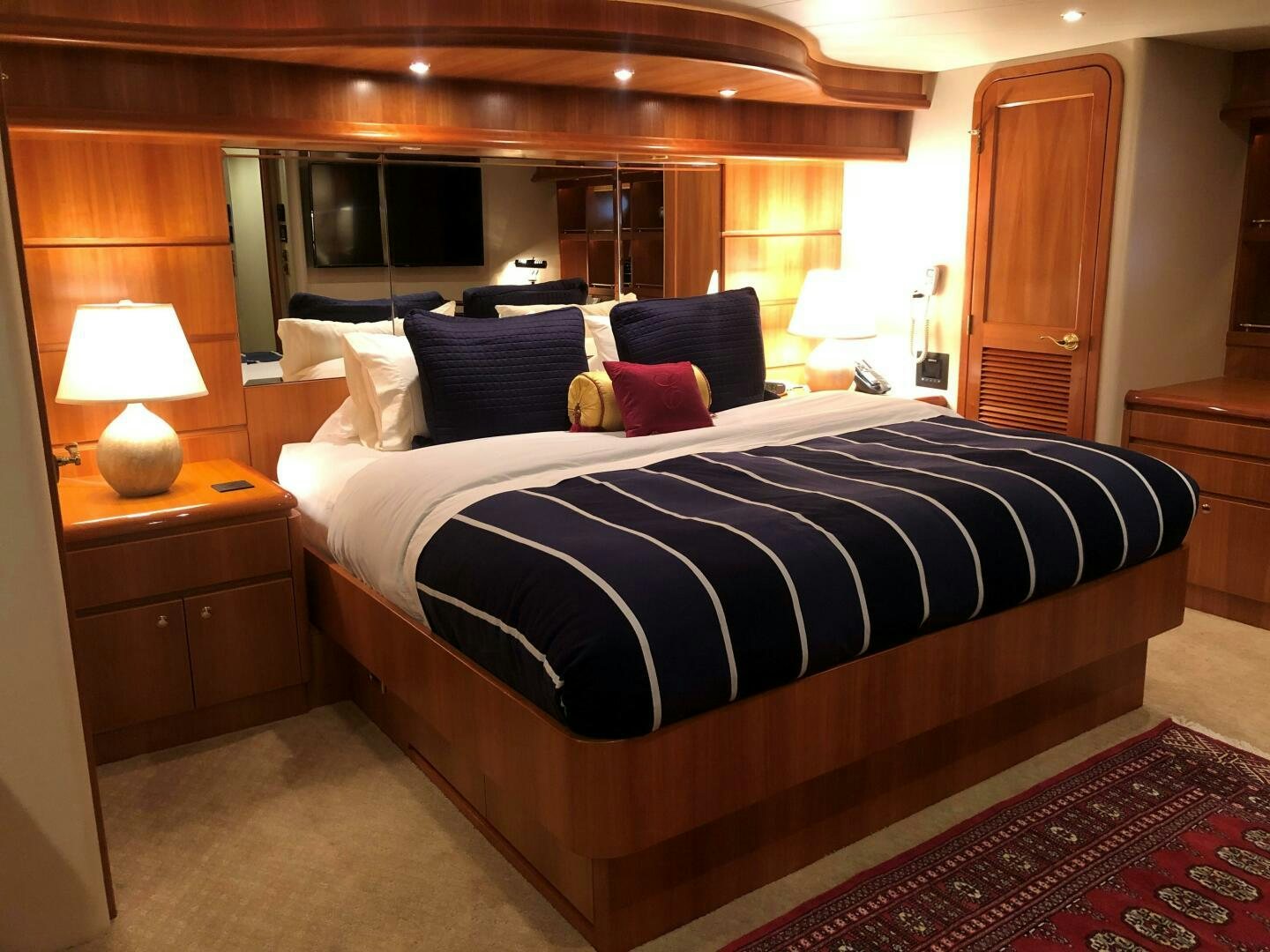 a bed with a black and white bed spread aboard ENCHANTRESS Yacht for Sale
